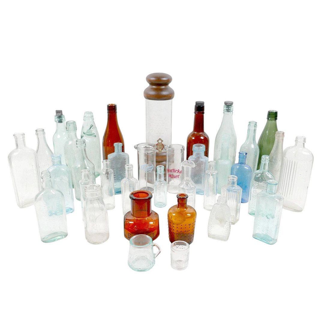THIRTY-SIX VINTAGE GLASS BOTTLES AND CONTAINERS.