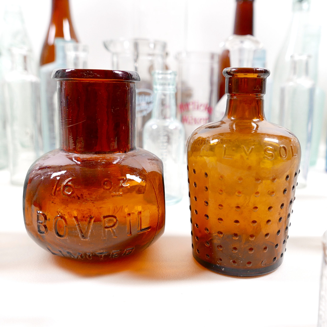 THIRTY-SIX VINTAGE GLASS BOTTLES AND CONTAINERS.