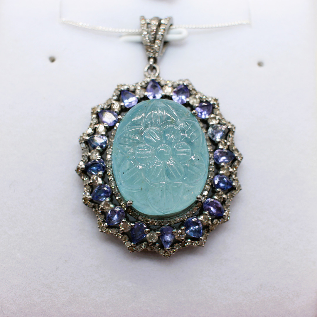CARVED AQUAMARINE, DIAMOND & TANZANITE PENDANT.