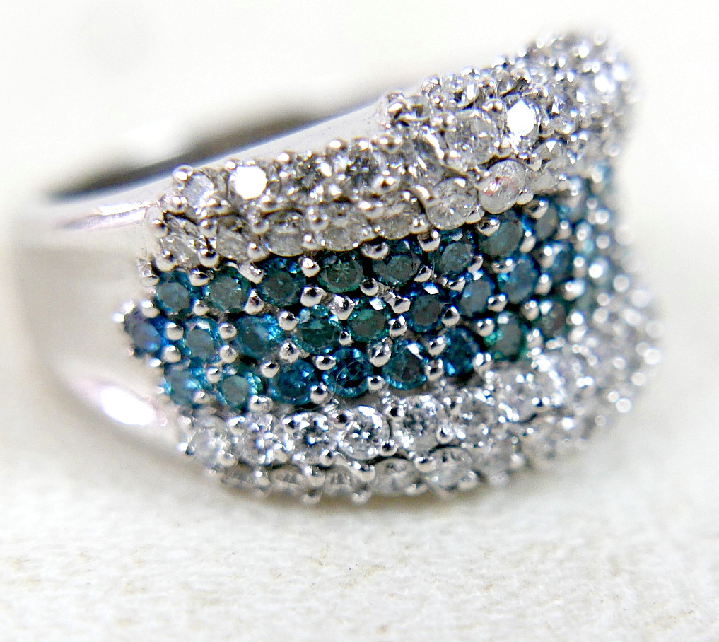 AN 18K WHITE GOLD, DIAMOND, AND BLUE DIAMOND RING.