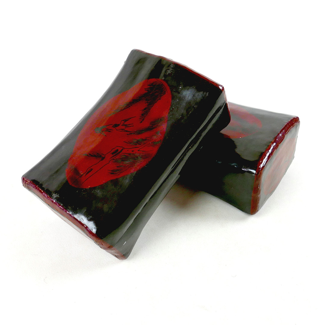 A PAIR OF CHINESE OR JAPANESE LACQUERED PAPER MACHE PILLOWS.