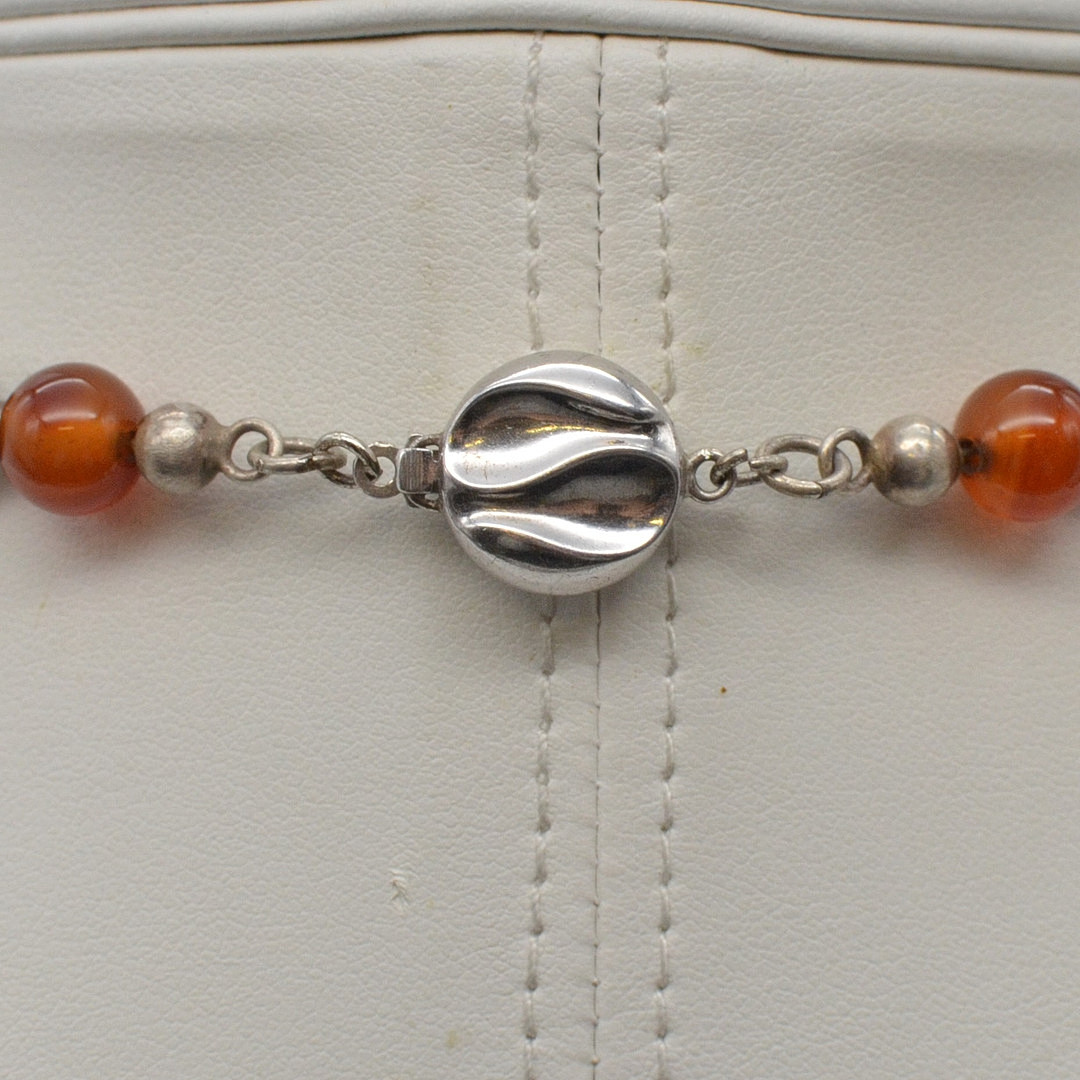 J. KÖHLE, DESIGNERCOLLIER MIT EINEM ANHÄNGER MIT ACHAT CABOCHON, FASSUNG AUS STERLINGSILBER, PERLEN AUS ACHAT, DEUTSCHLAND (PFORZHEIM), UM 1970ER JAHRE.