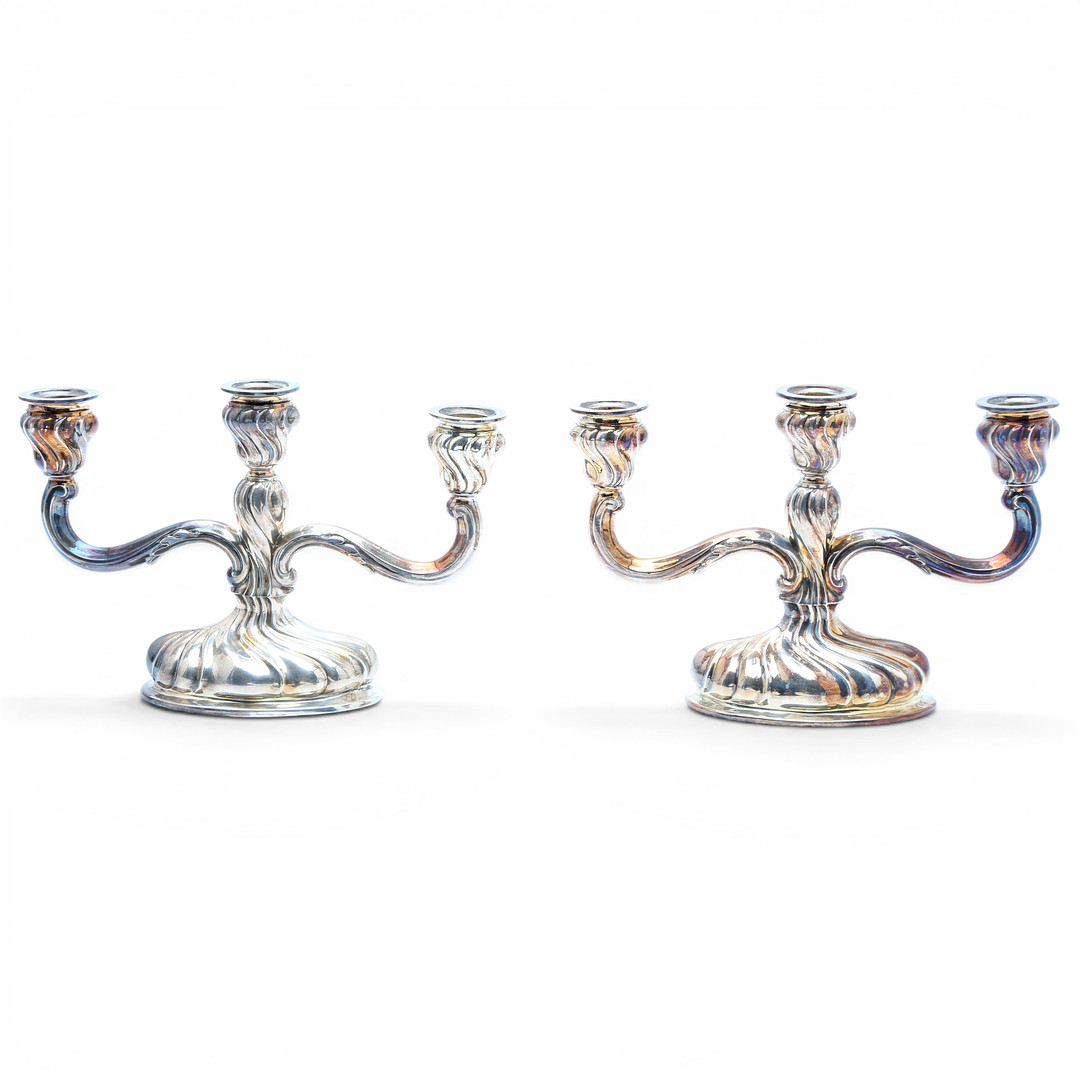 Pair of candelabra and pair of table lamps in silver, third quarter of the 20th Century.