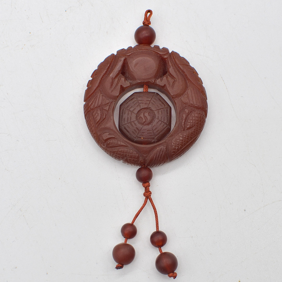 CHINESISCHES JADE AMULETT, TAICHI MUSTER UND DRACHEN, ROT, 20. JAHRHUNDERT.