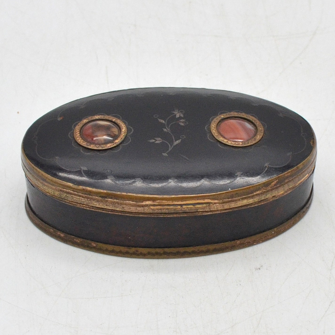 RUSSISCHE LACKDOSE, KLAPPDOSE IN SCHWARZ MIT BLUMENDEKOR, FASSUNG AUS HOLZ UND VERGOLDETEM KUPFER, MIT INTARSIEN AUS ACHAT, 19. JAHRHUNDERT.