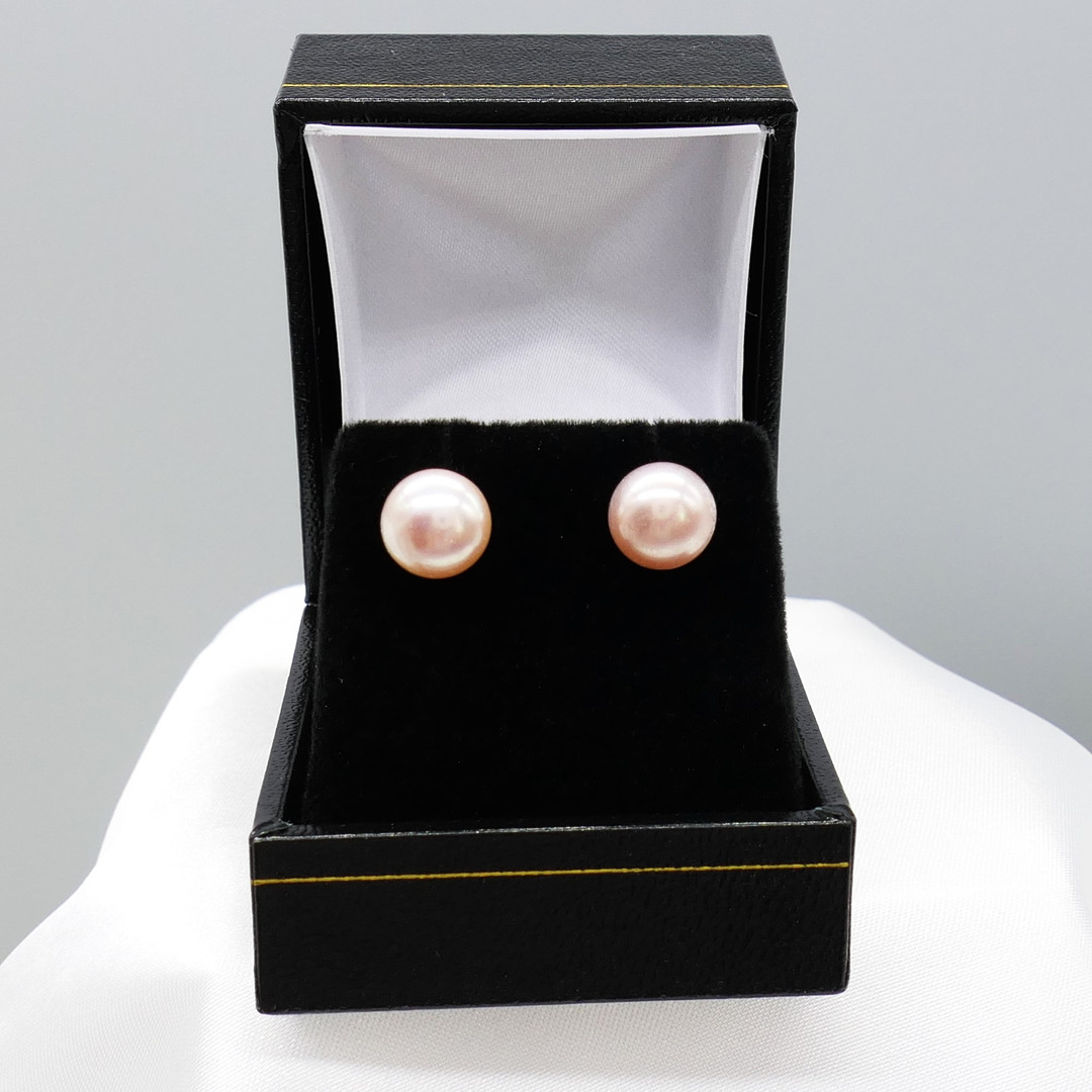 CULTURED PEARL studs in white gold.