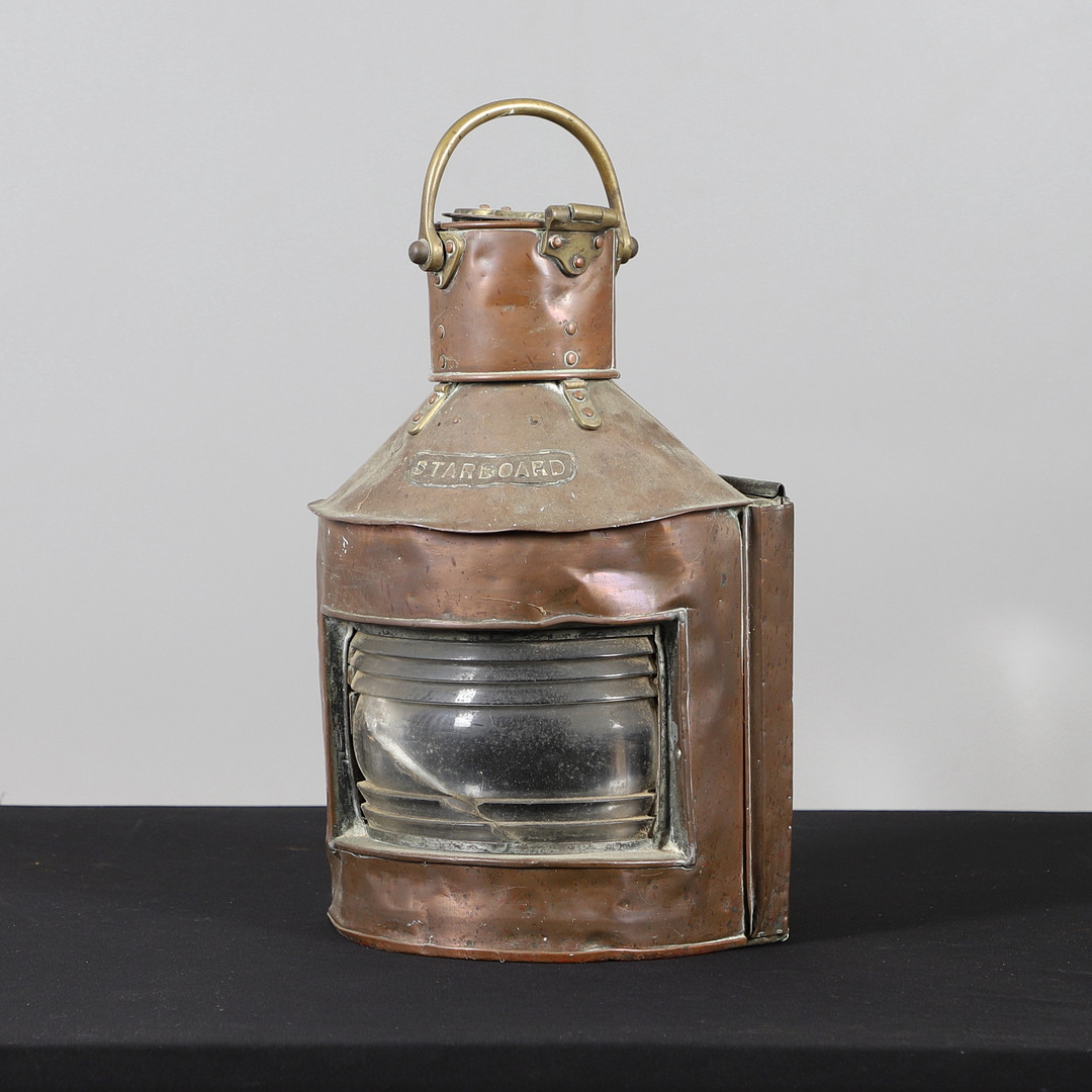 A COPPER AND BRASS STARBOARD SHIPS LANTERN.