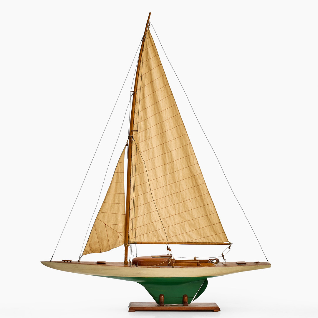 BÅTMODELL, enmastad segelbåt, 1900-tal, delvis målat trä med segel i textil, på ställning.