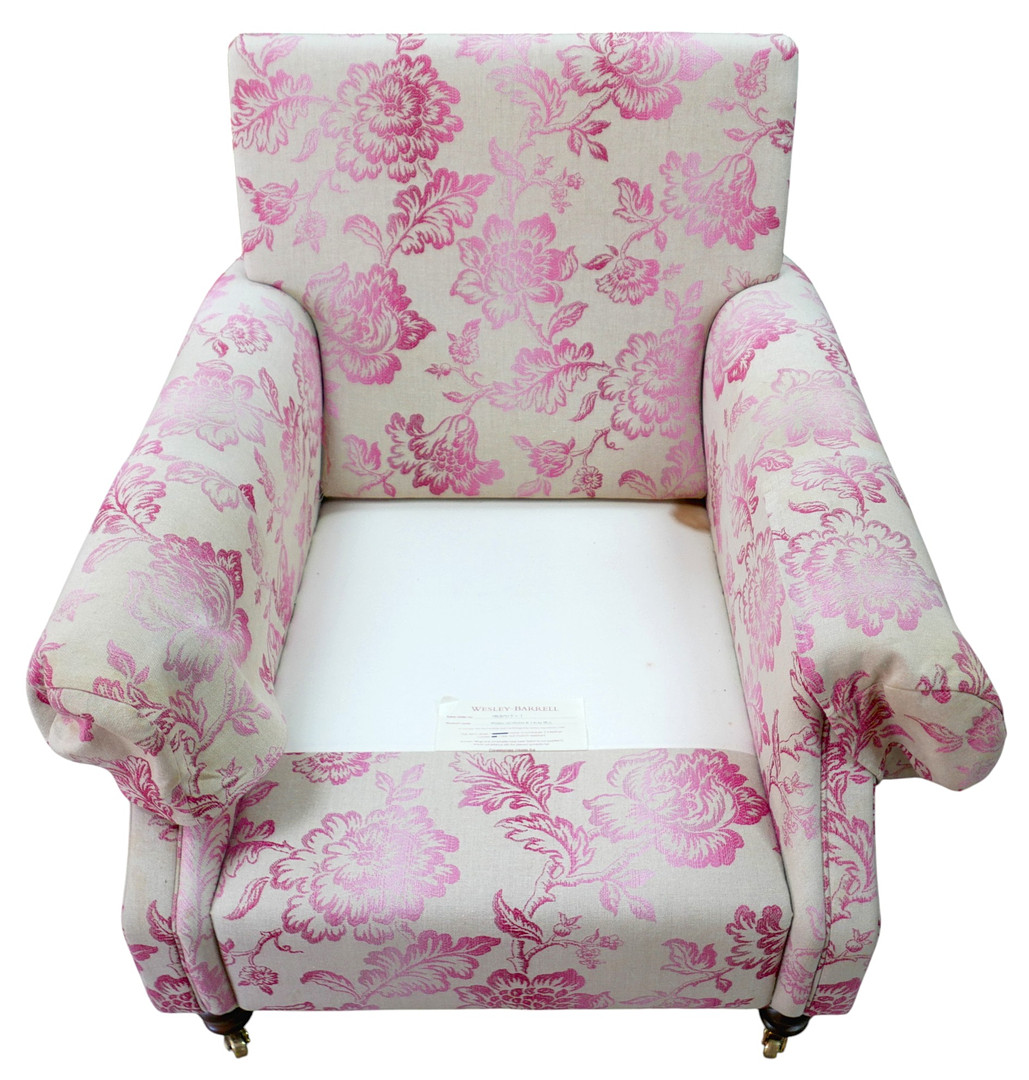 A 20TH CENTURY RECTANGULAR BACKED ARMCHAIR.