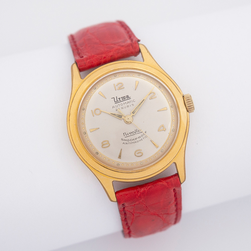 VINTAGE ARMBANDUHR DER MARKE URWA, VERGOLDETES GEHÄUSE, GOLDPLATED, AUTOMATIC, 25 RUBIS, SHOCKPROOF, ANTIMAGNETIC, WATERPROOF, 1950ER JAHRE, ROTES LEDERARMBAND.