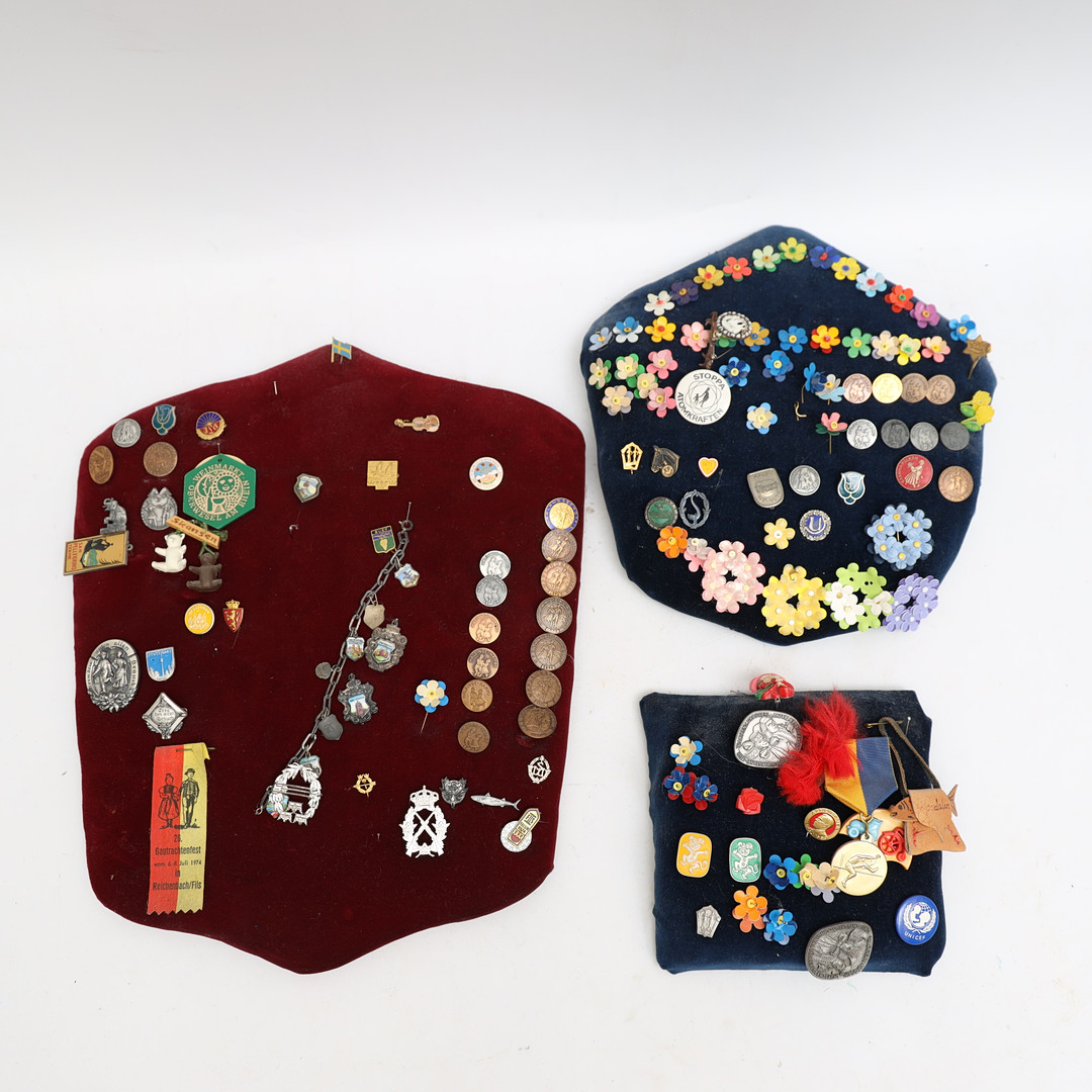 PINS & MÄRKEN, monterade på sköldar.