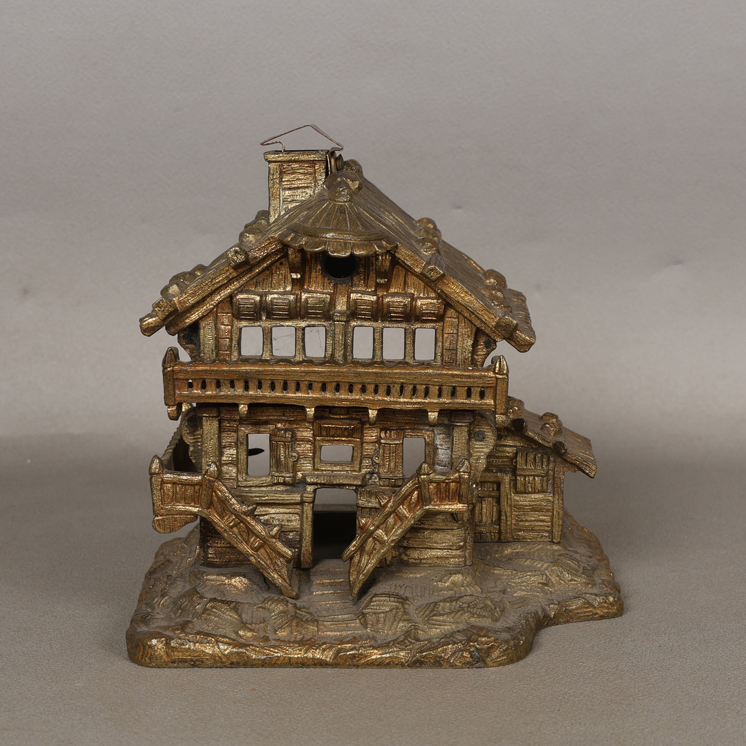AN UNUSUAL GILT BRASS NIGHT LIGHT IN THE FORM OF CHALET.