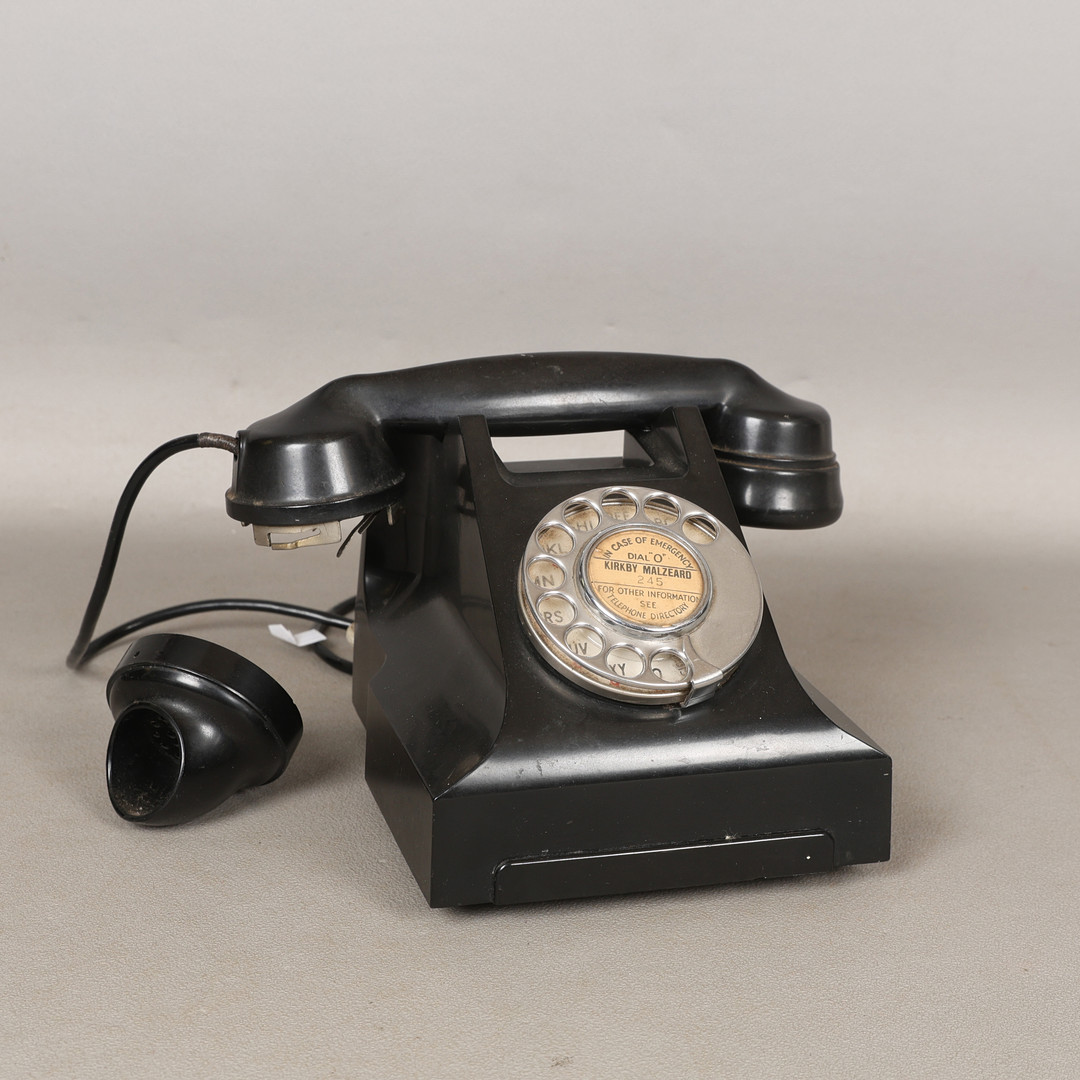 A BLACK BAKELITE TELEPHONE.