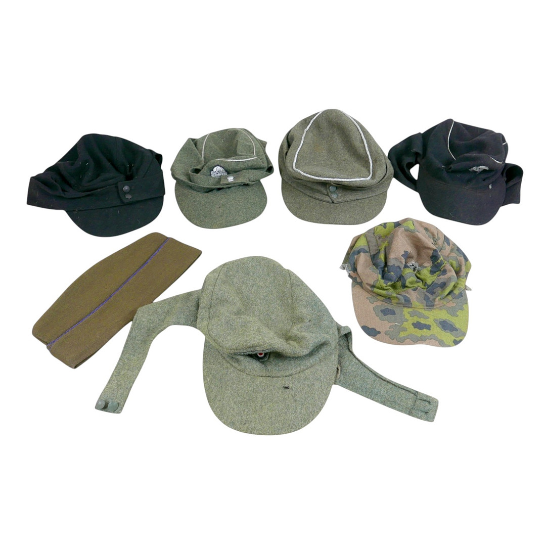 ONE US AND SIX GERMAN WORLD WAR II STYLE MILITARY CAPS.