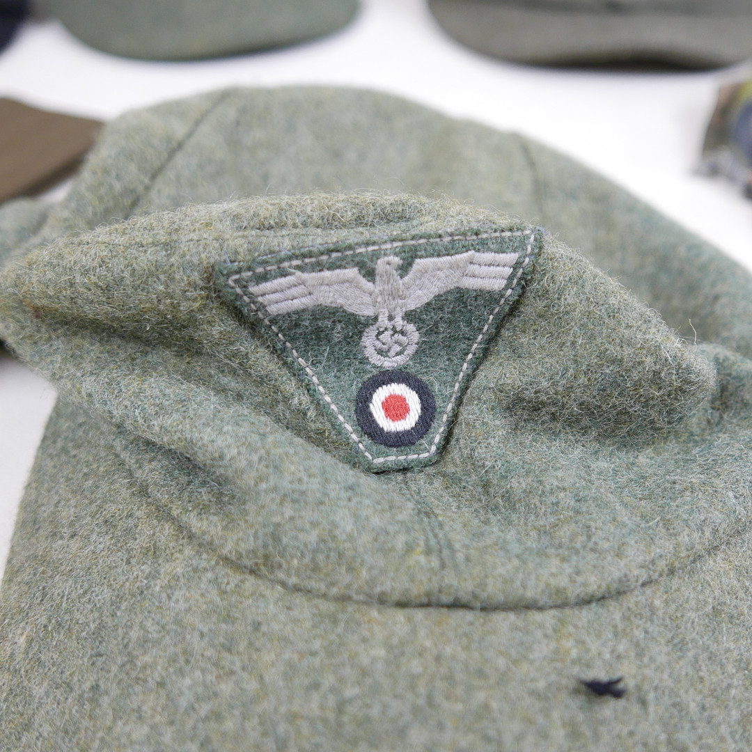 ONE US AND SIX GERMAN WORLD WAR II STYLE MILITARY CAPS.