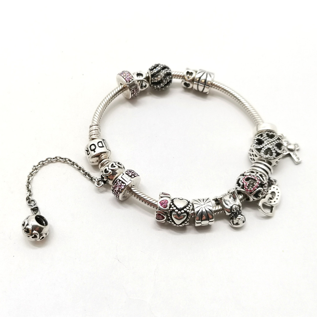 PANDORA SILVER BRACELET W/ CHARMS.
