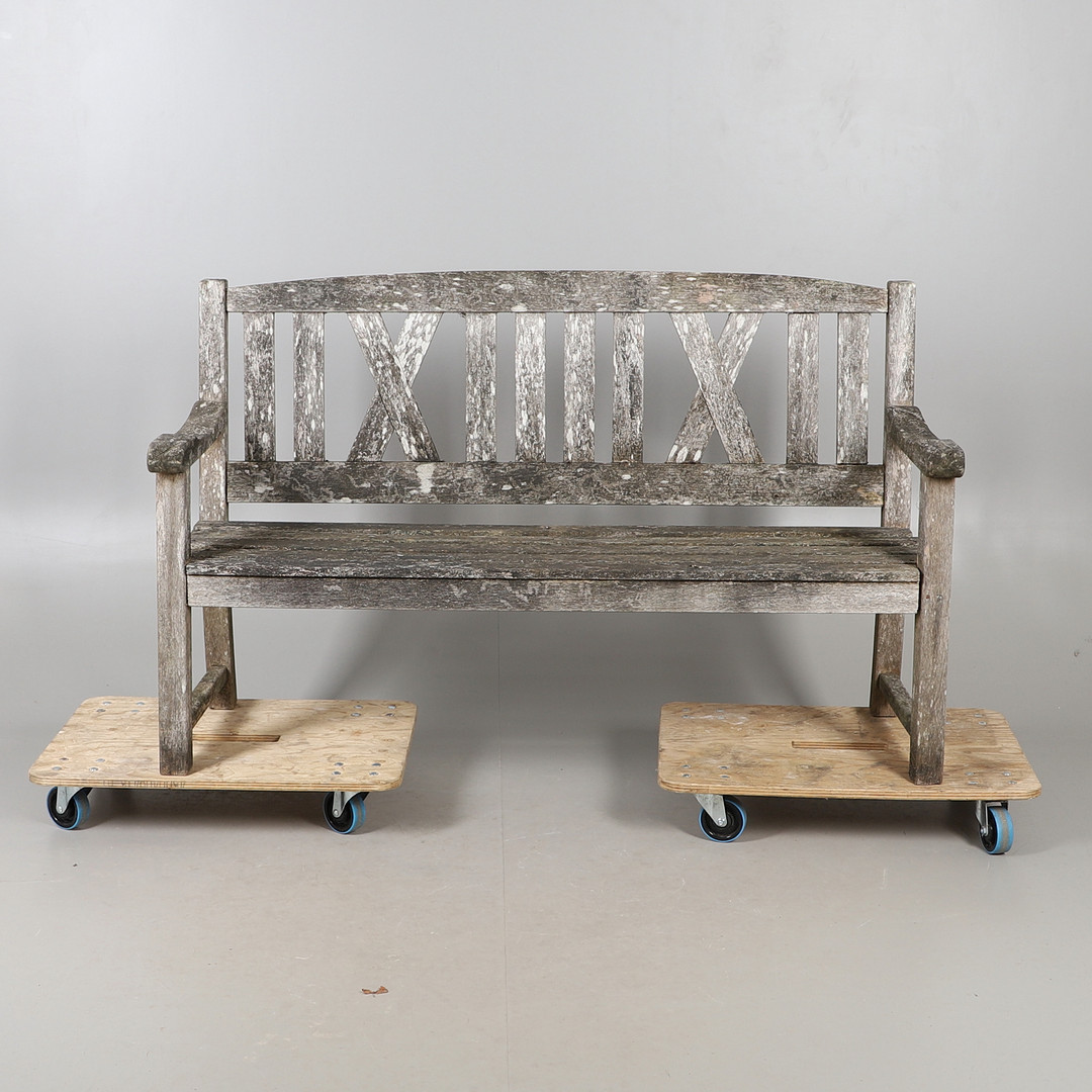 A LARGE WOODEN GARDEN BENCH.