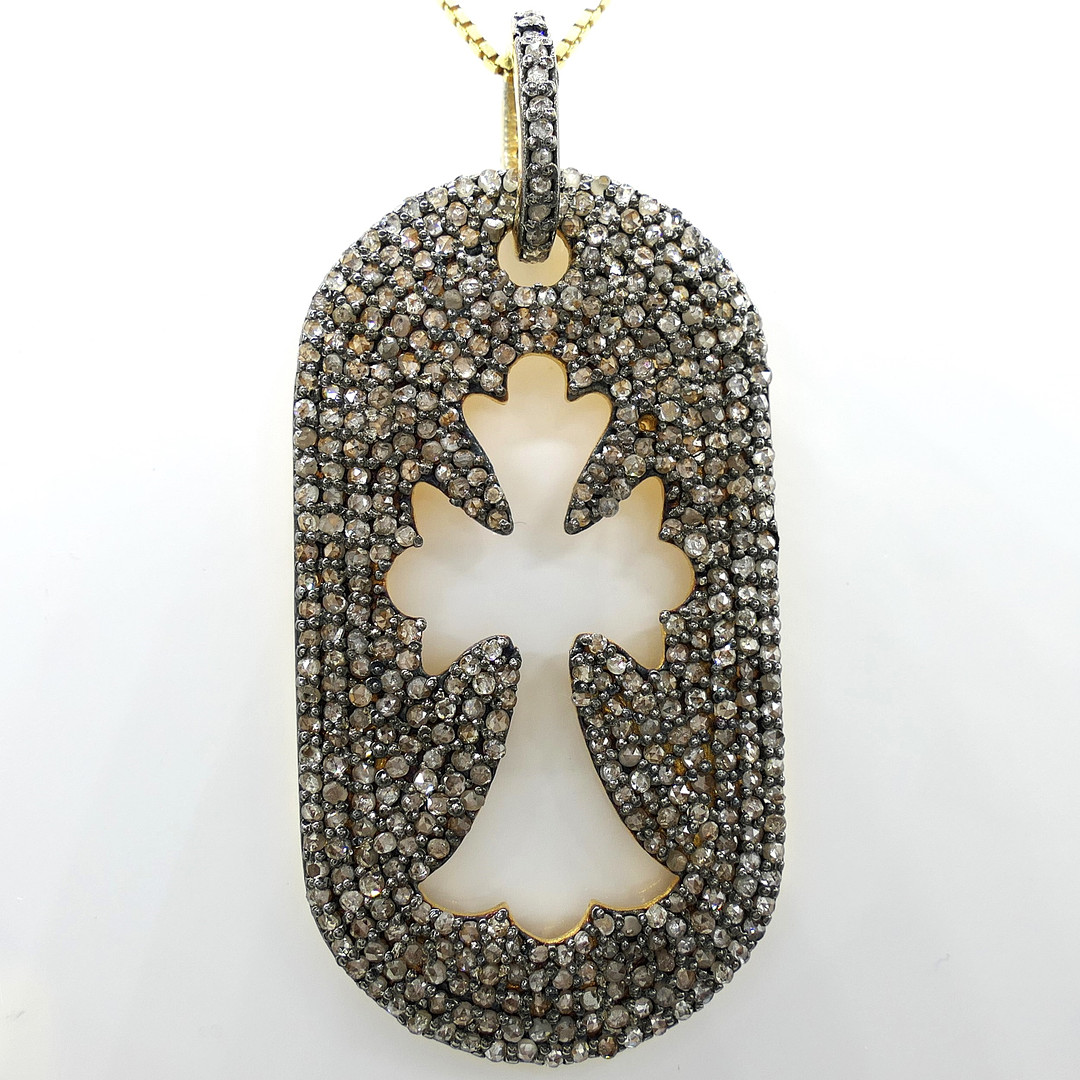 DIAMOND ENCRUSTED cross necklace.