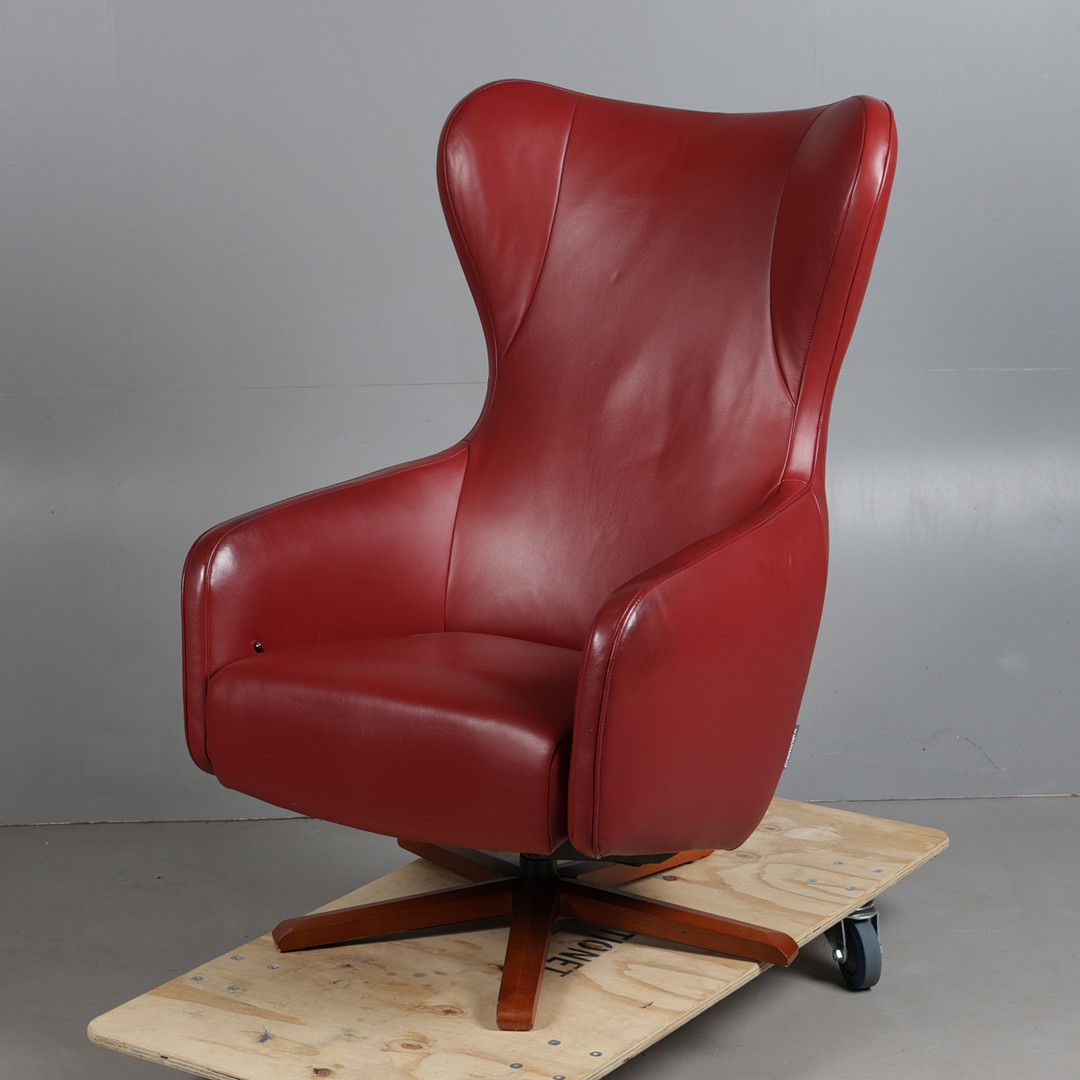 A PROMINENT FURNITURE SWIVEL CHAIR.