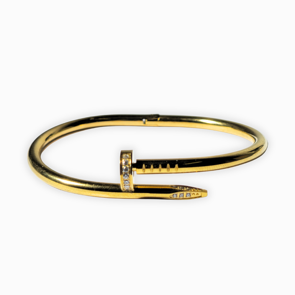 Pulsera clavo en acero con baño de oro.
