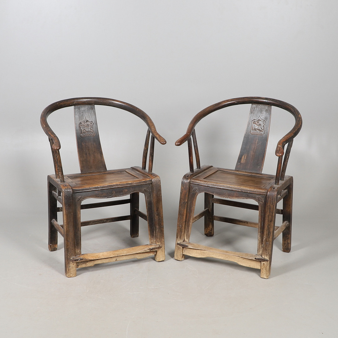 A PAIR OF 19TH CENTURY CHINESE ELM ELBOW CHAIRS.