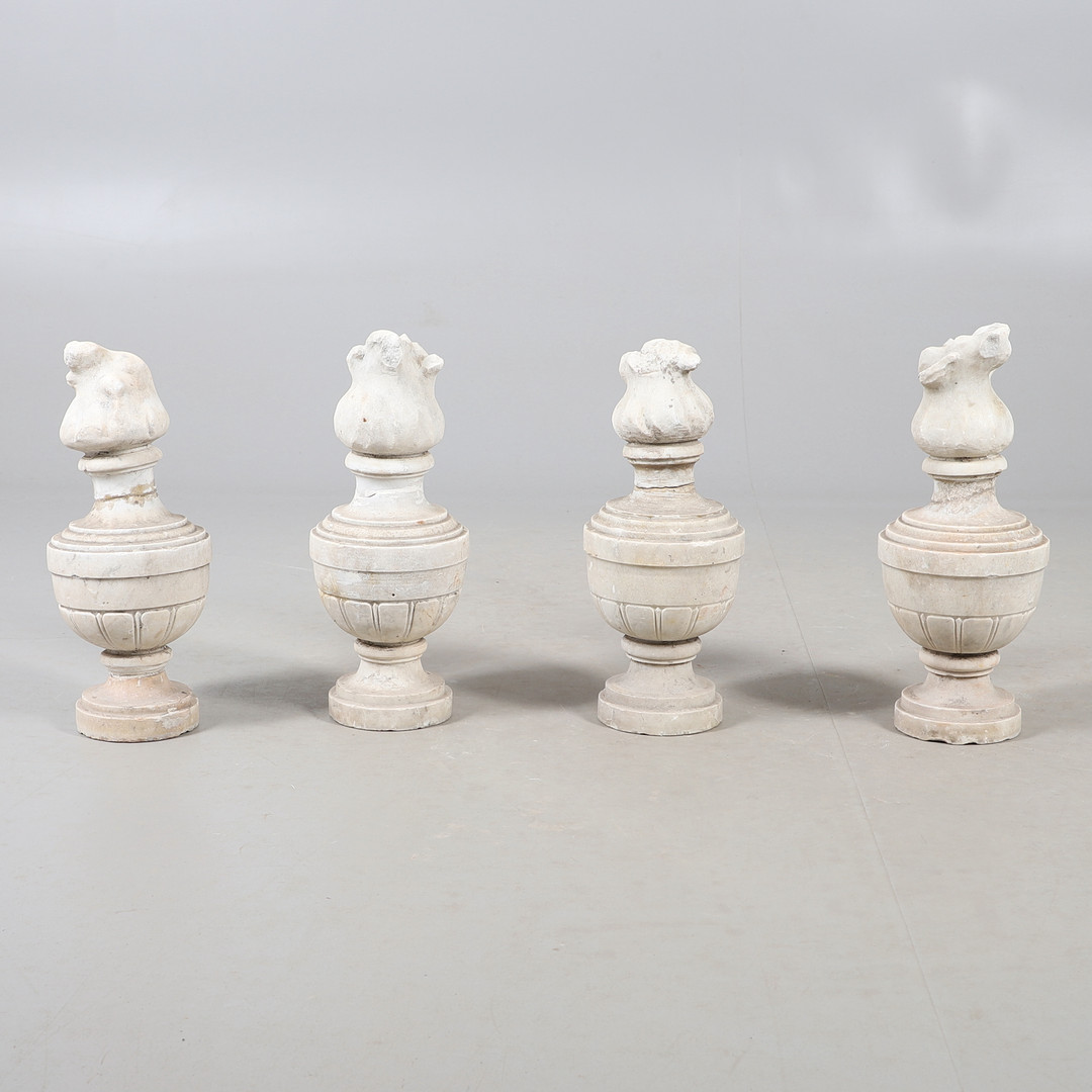 SET OF FOUR CARVED MARBLE FLAME FINIAL SCULPTURES.