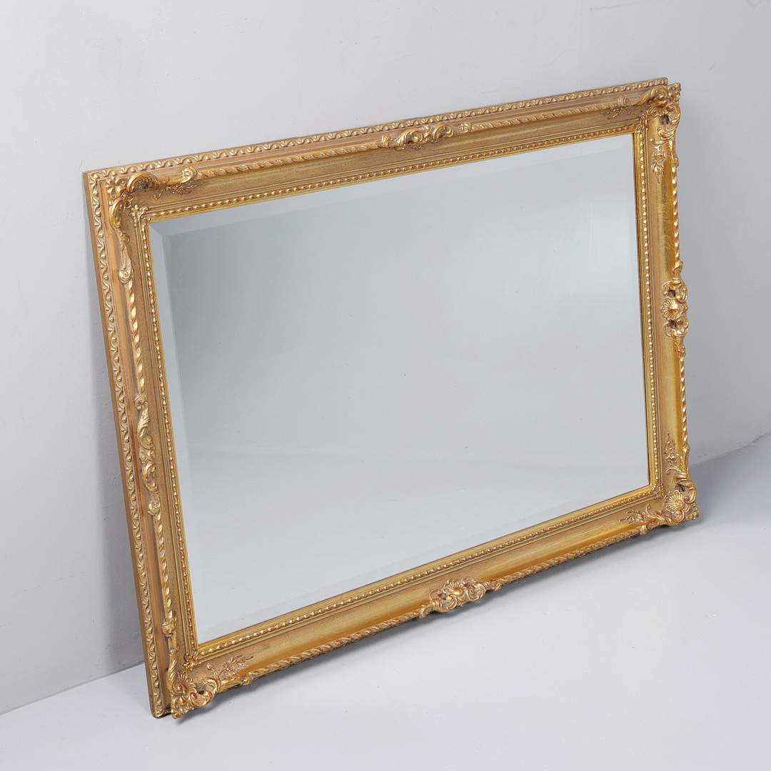 CARVED AND MOULDED GILT WALL MIRROR.