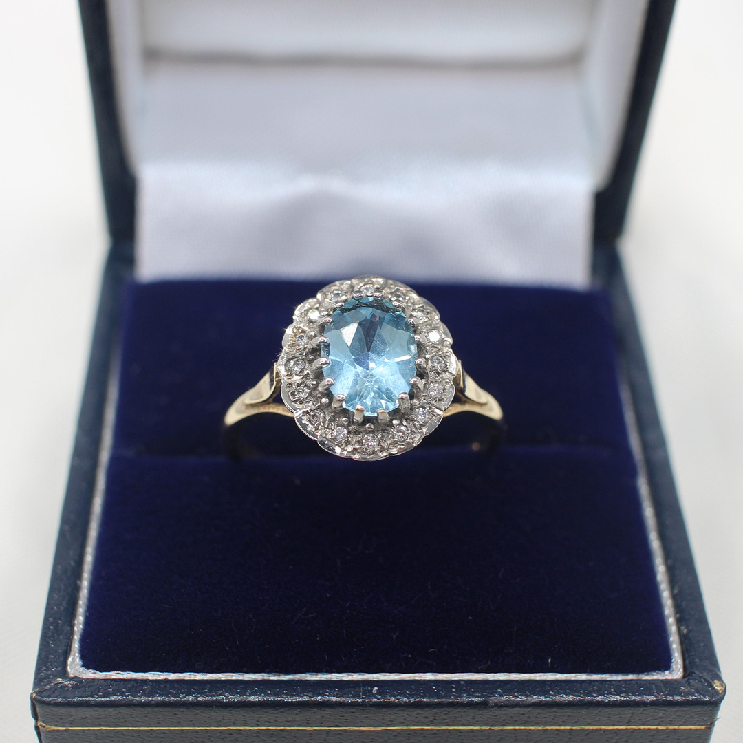 BLUE TOPAZ & DIAMOND CLUSTER RING.