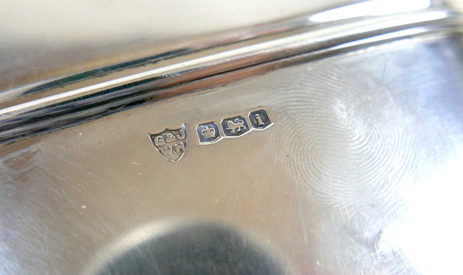 A GEORGE V SILVER HIP FLASK.