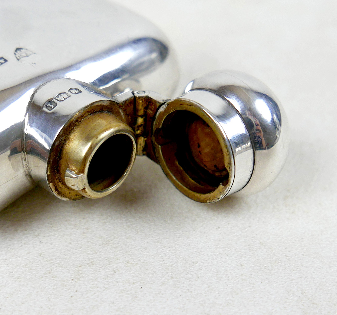 A GEORGE V SILVER HIP FLASK.