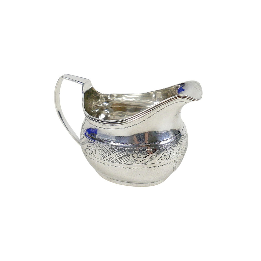 A GEORGE III SILVER MILK JUG.