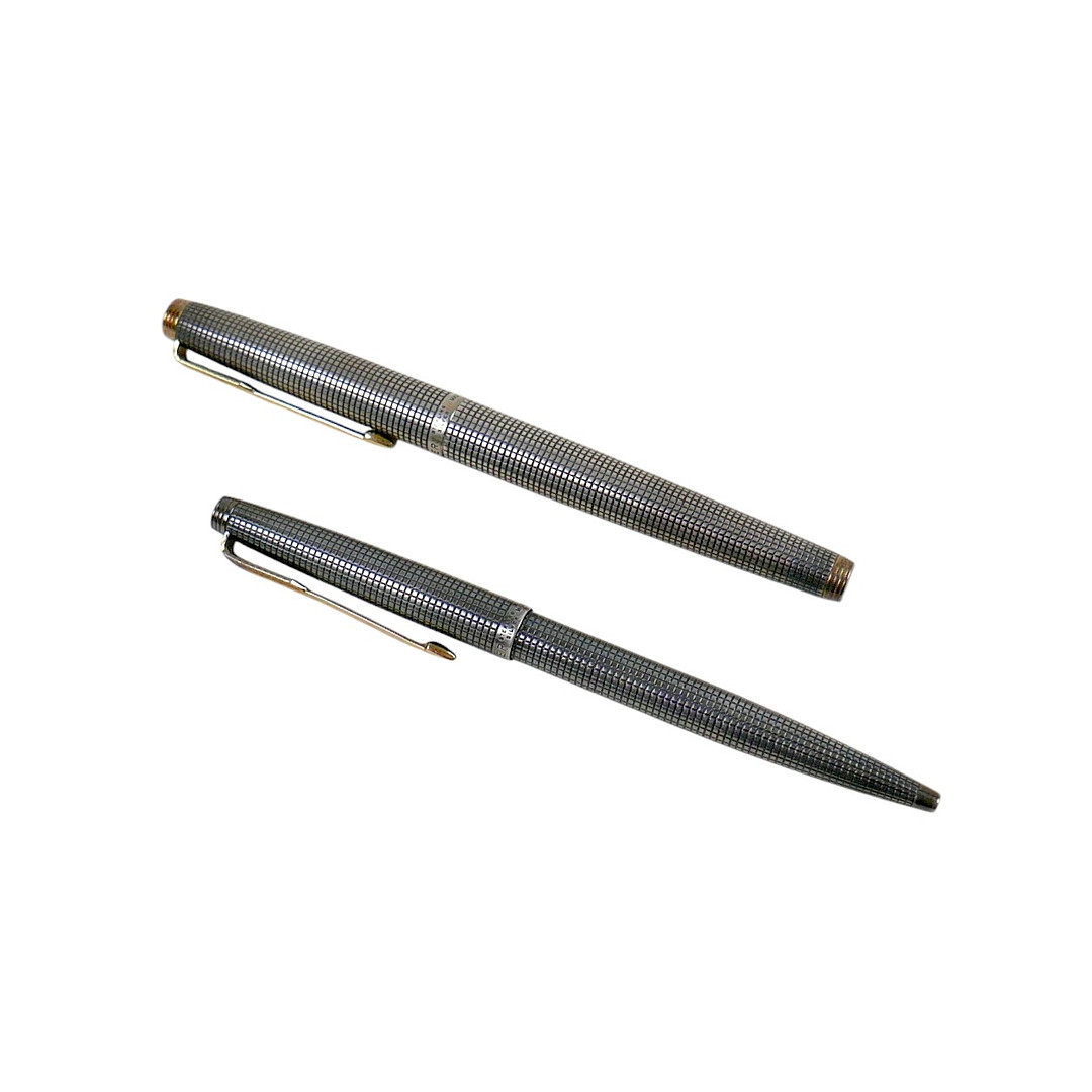 A SILVER CASED GOLD NIBBED PARKER FOUNTAIN PEN AND A BALL-POINT PEN.