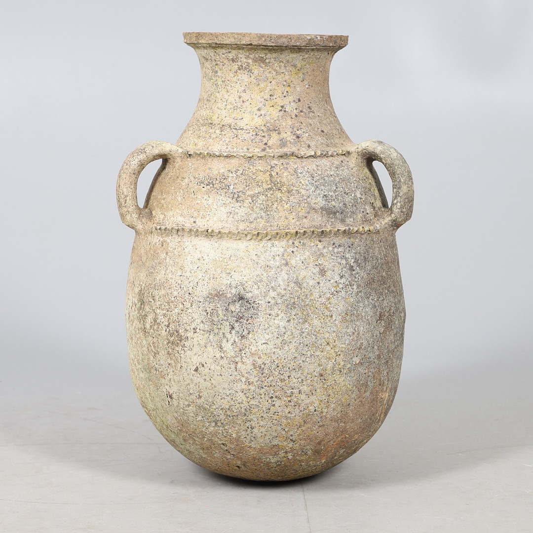 A TERRACOTTA THREE HANDLED AMPHORA.