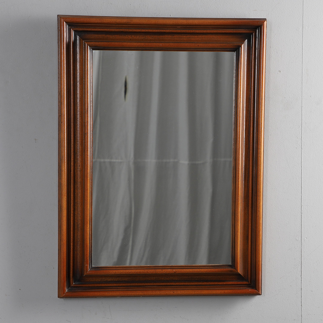 A CONTEMPORARY WOOD FRAMED MIRROR.