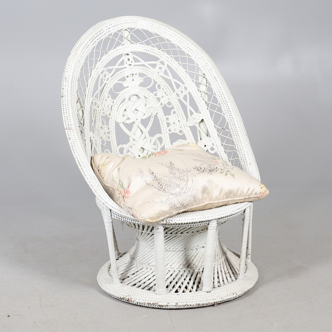 AN EARLY TWENTIETH CENTURY PAINTED CANE PEACOCK GARDEN CHAIR.