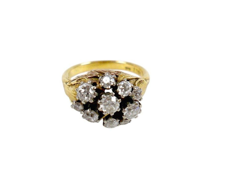 AN 18CT GOLD RING SET WITH TEN BRILLIANT CUT DIAMONDS.