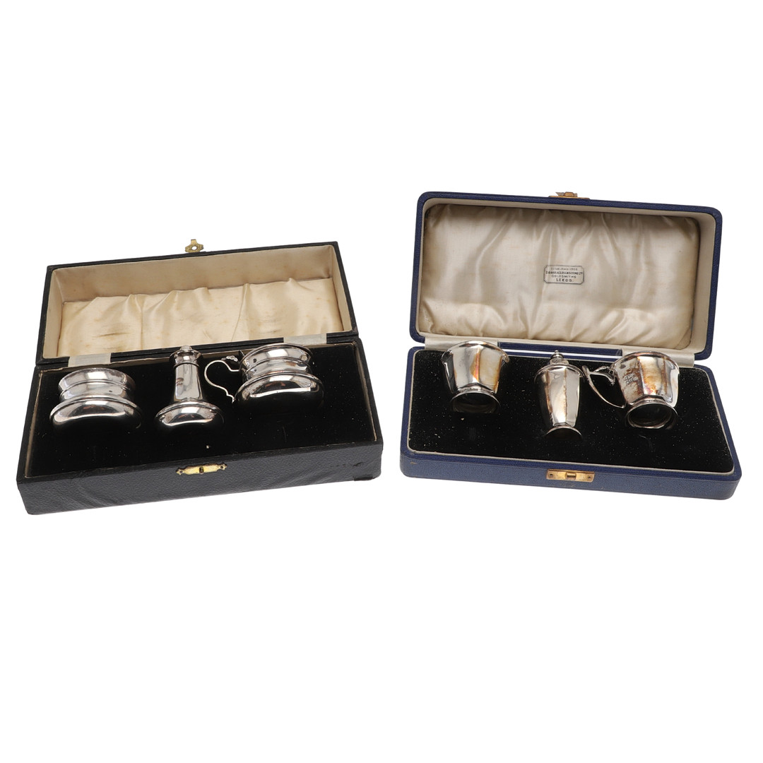 TWO CASED SILVER CRUET SETS.