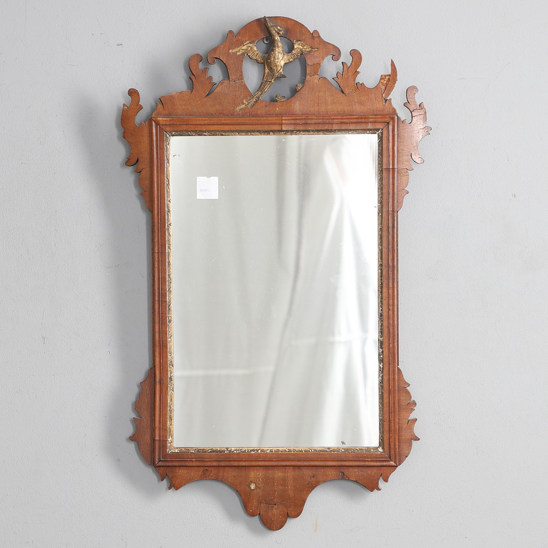 AN 18TH CENTURY FRET CARVED WALL MIRROR.