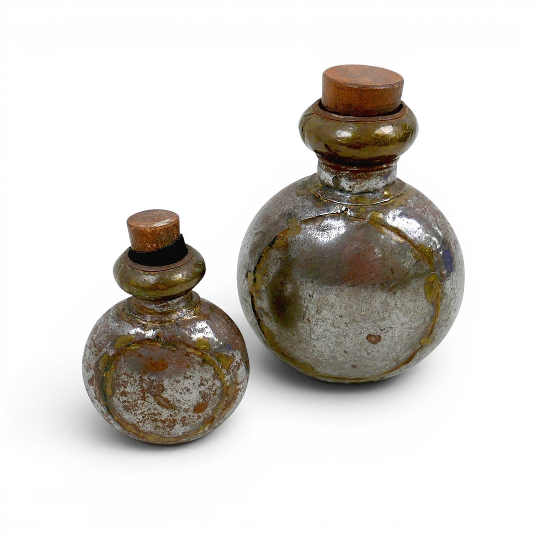 TWO WHITE METAL CORKED PROP FLASKS FROM THE MOVIE GLADIATOR (2000).