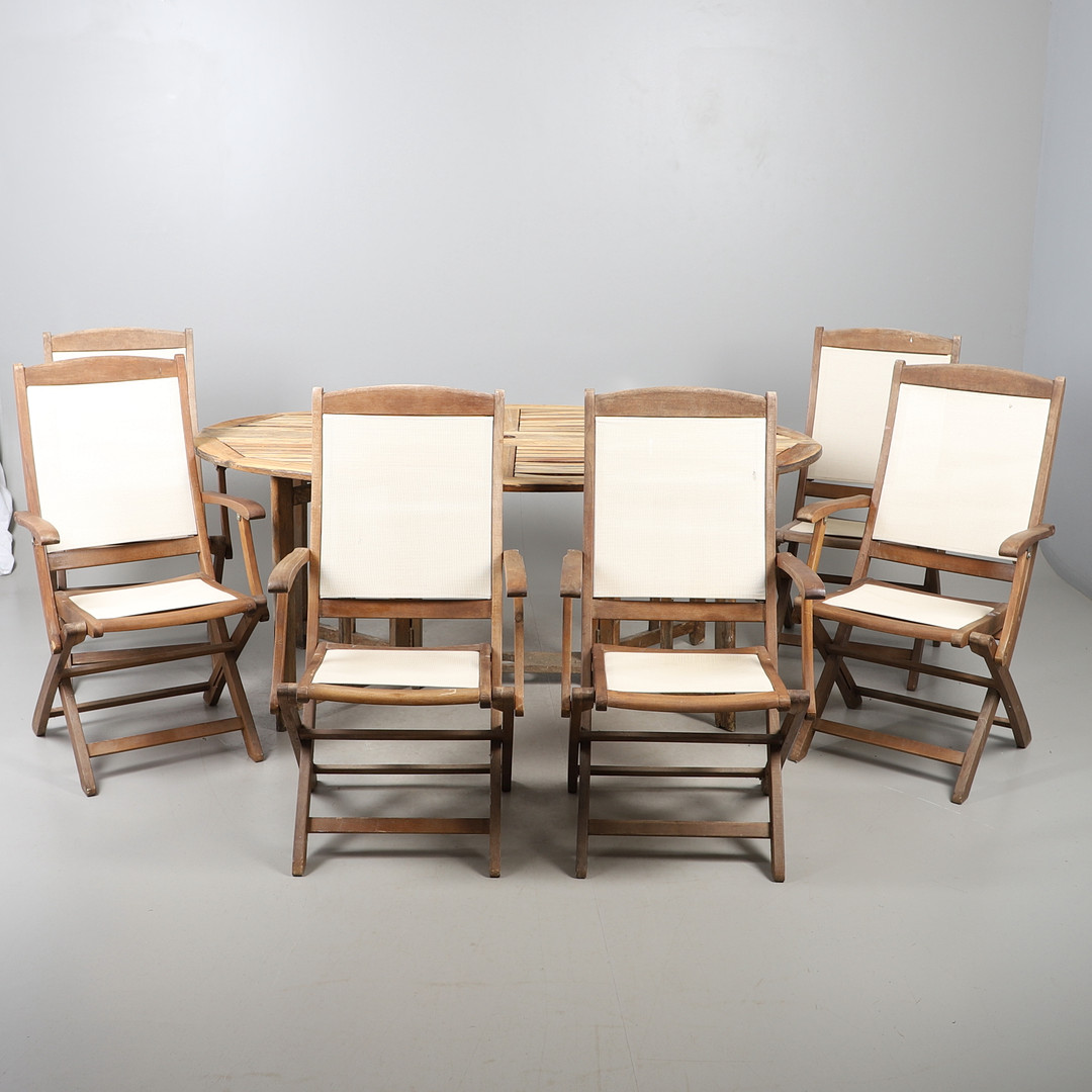 A LARGE GARDEN DINING TABLE AND A SET OF SIX CHAIRS.