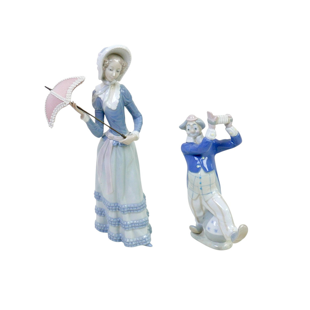 A LLADRO GIRL WITH PARASOL AND A NAO CLOWN.