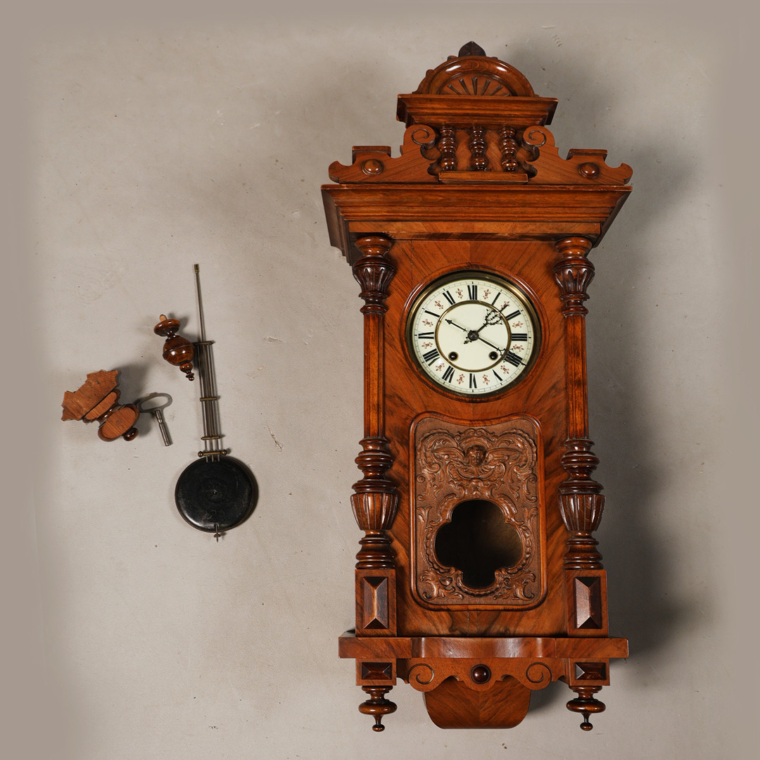 A 20TH CENTURY WALNUT WALL CLOCK.