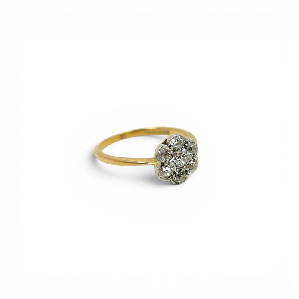AN 18CT GOLD, PLATINUM AND DIAMOND FLOWERHEAD RING.