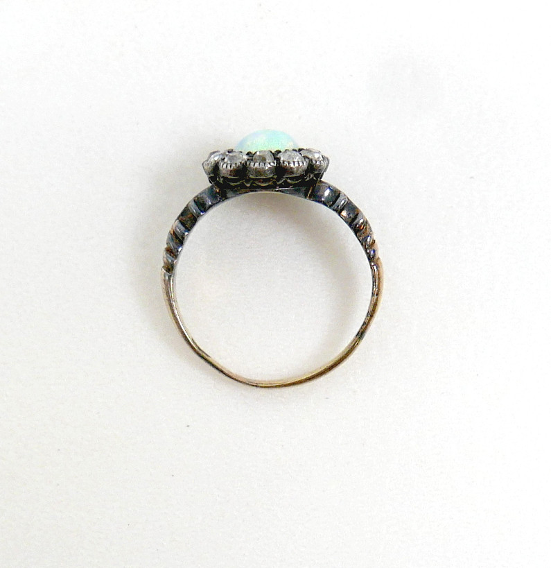 AN 18CT GOLD OPAL AND DIAMOND DAISY RING.
