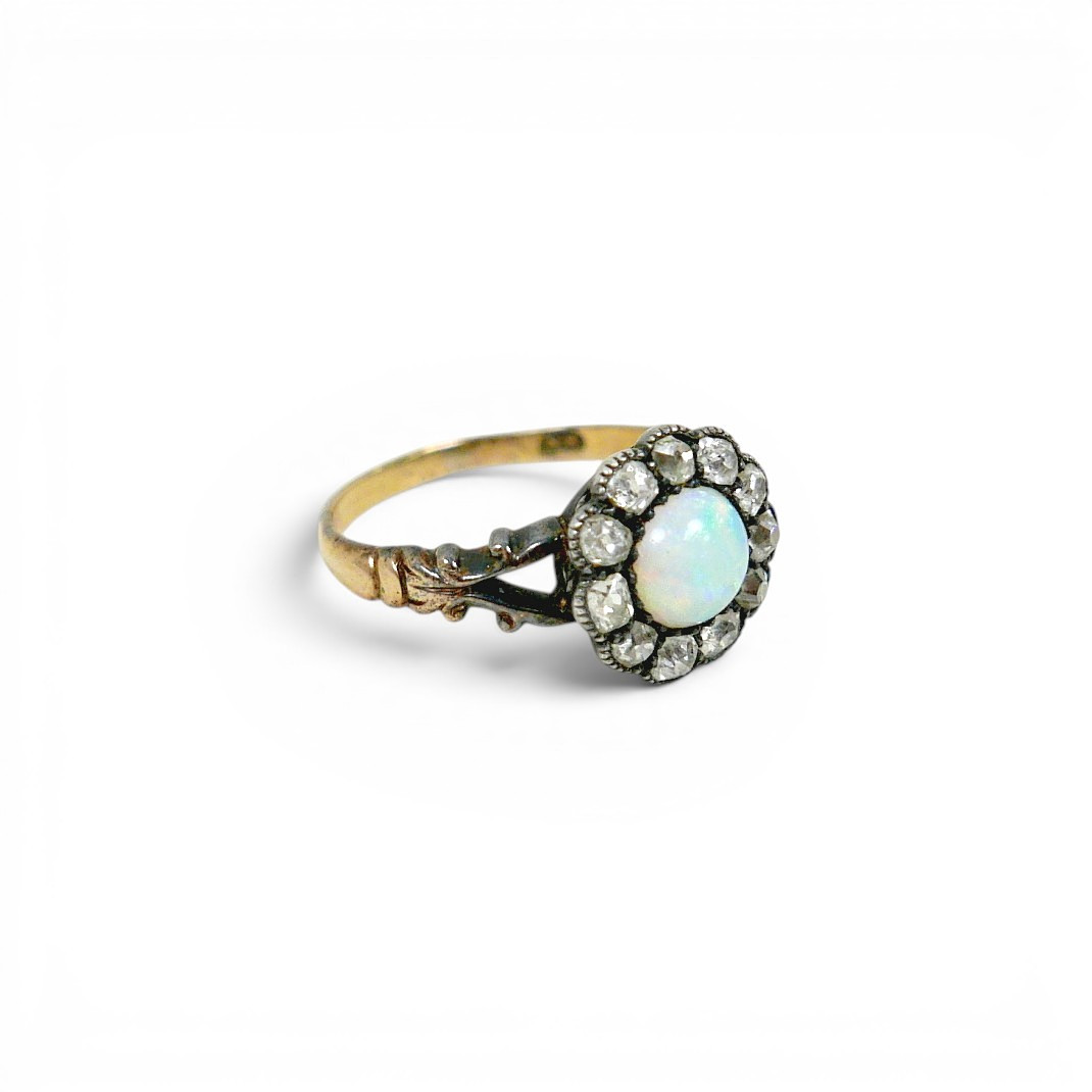 AN 18CT GOLD OPAL AND DIAMOND DAISY RING.