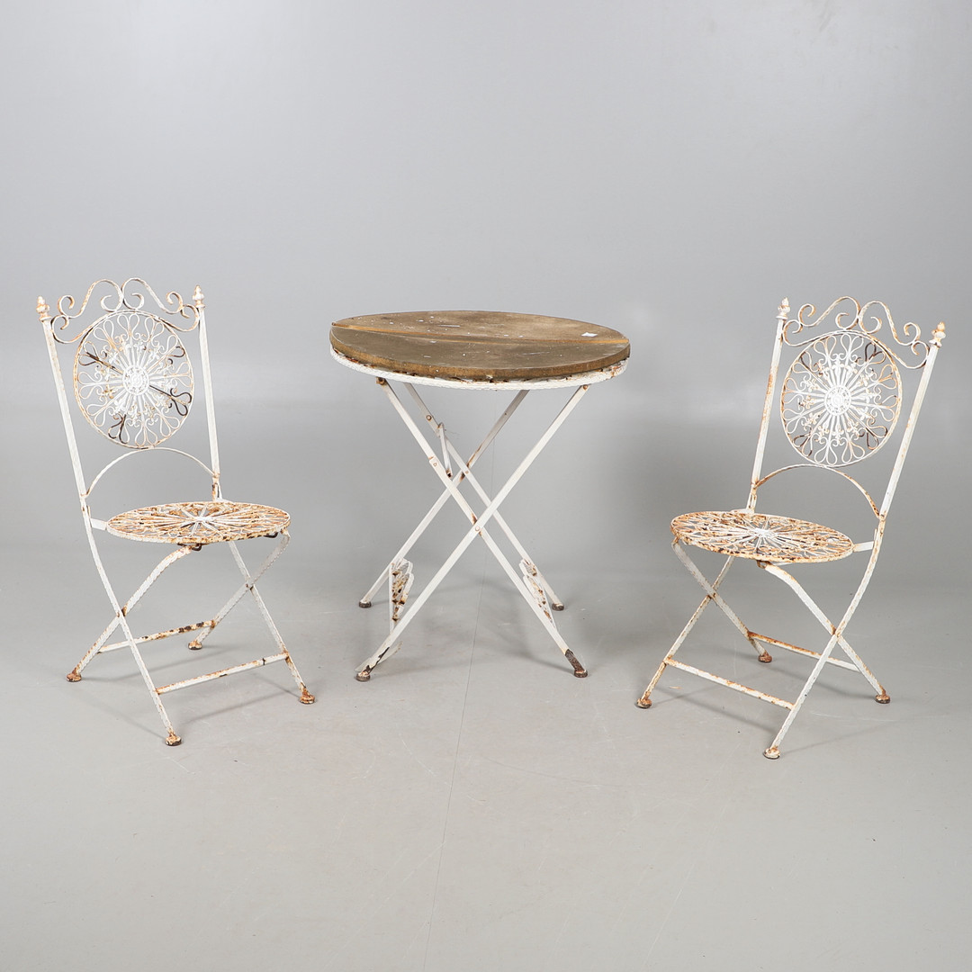 A WROUGHT GARDEN TABLE AND TWO CHAIRS.