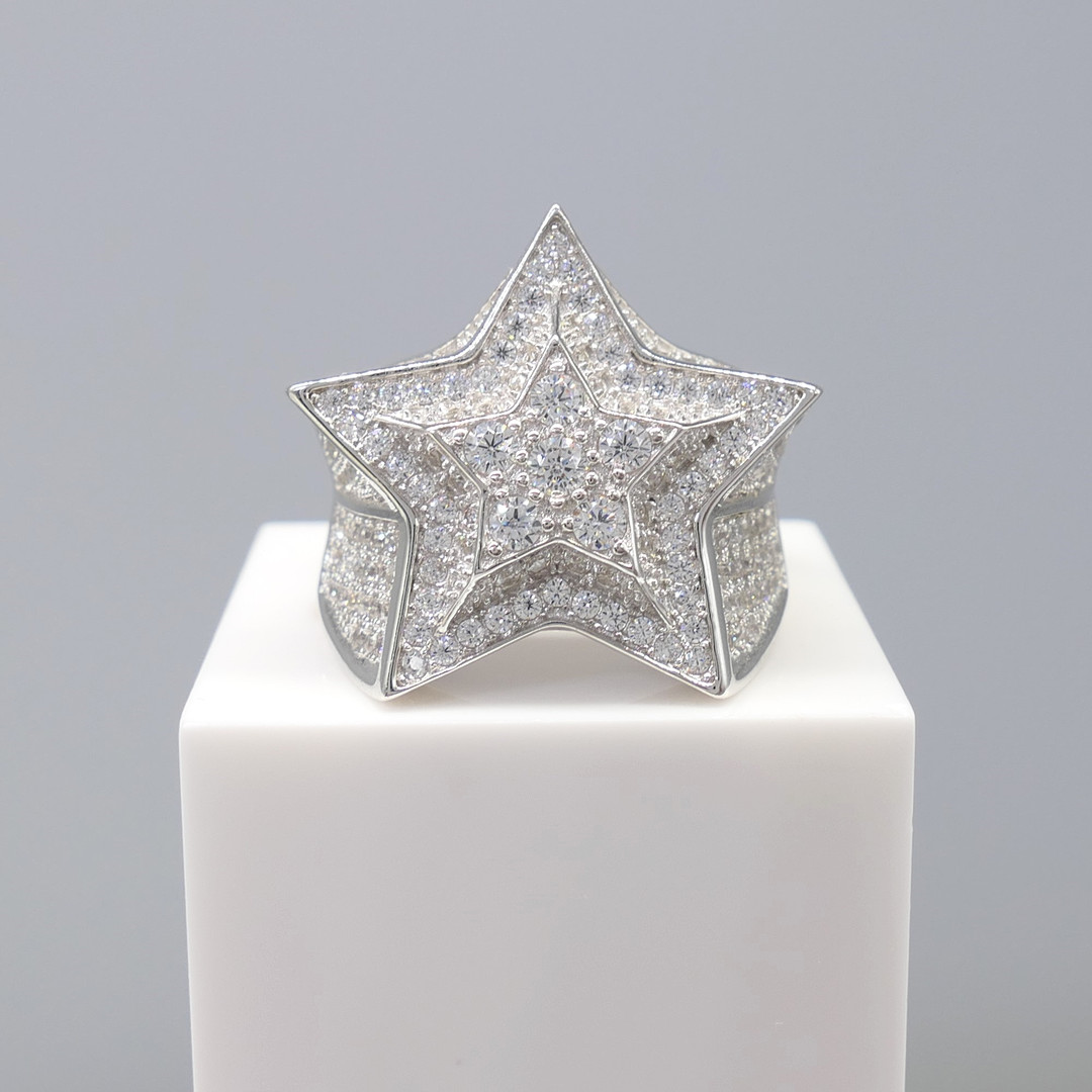 STAR-SHAPED SILVER dress ring.