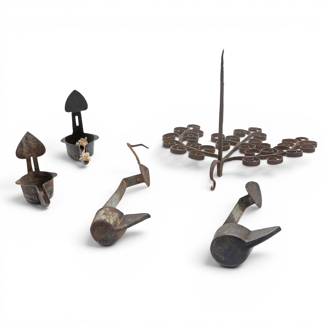 Four iron oil lamps, 19th Century.