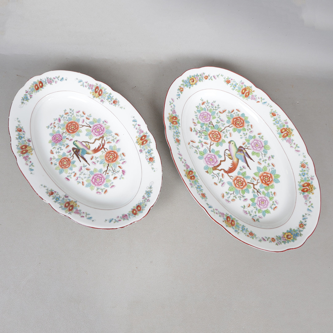 A PAIR OF EARLY 20TH CENTURY PORCELAIN MEAT PLATES RETAILED BY TEMPLE & CROOK (2).
