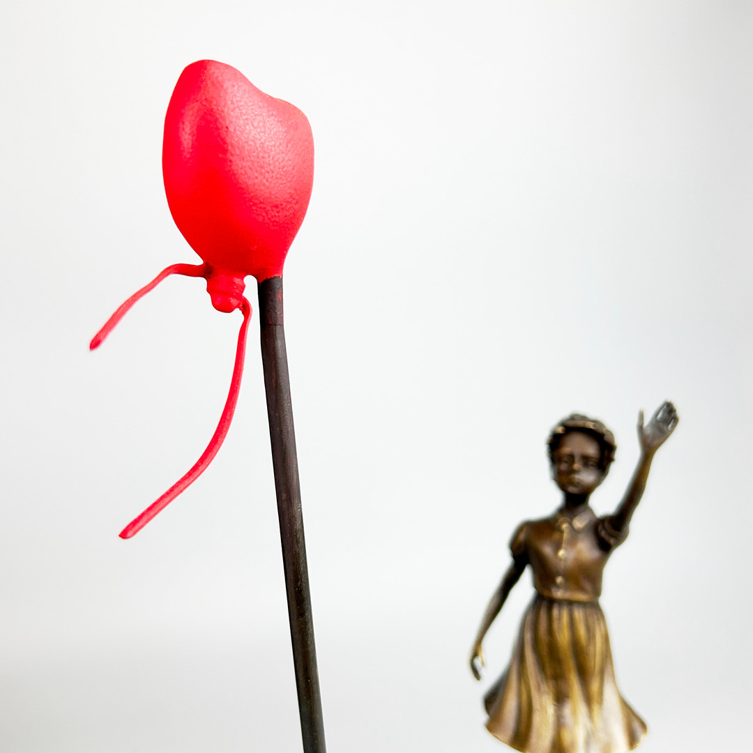 BRONZE BANKSY STYLE FIGURE.